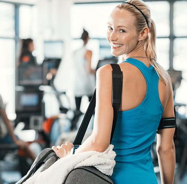 woman in gym wearing blue shirt